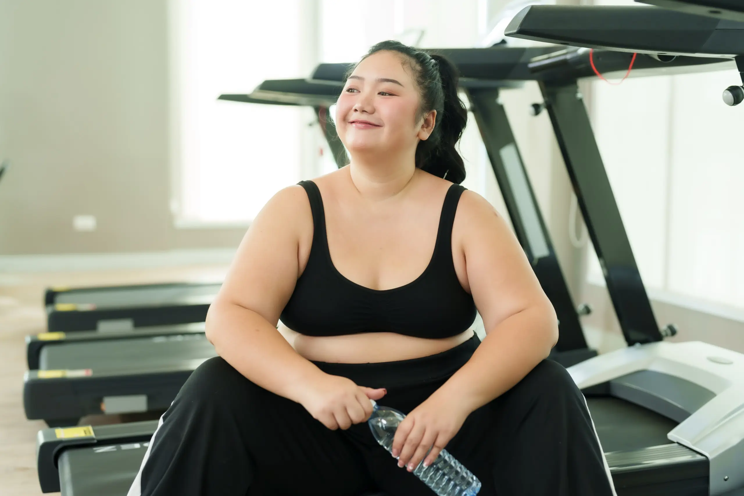 Plus size Asian woman exercise in gym