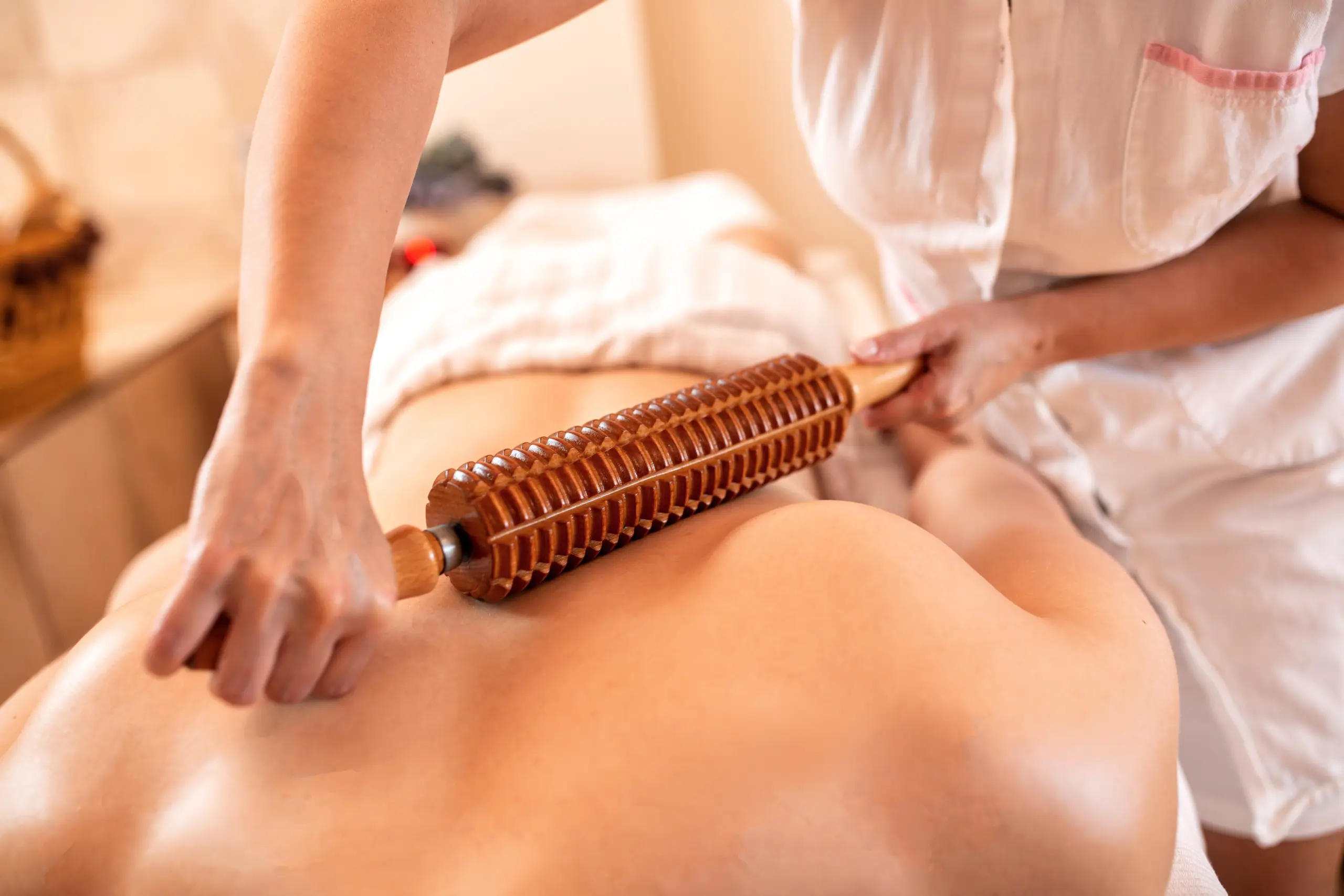 Special massage with a wooden roller tool, blood flow stimulation massage