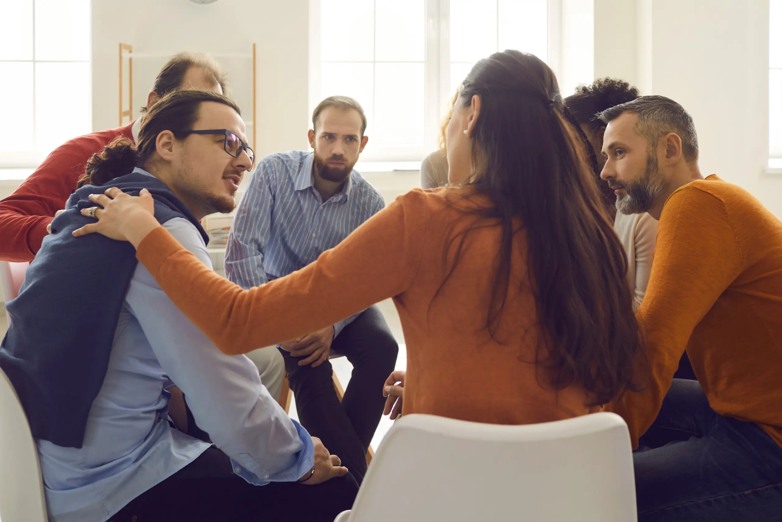 Group therapy session where individuals share progress and encourage each other
